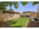 Well-maintained backyard featuring a lush lawn, wooden fence, covered patio, pergola, and hot tub area for outdoor enjoyment at 430 Osceola St, Denver, CO 80204