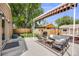 Relaxing backyard patio with awning, comfortable seating, a grill, hot tub, and a fenced yard for outdoor enjoyment at 430 Osceola St, Denver, CO 80204
