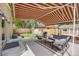Relaxing backyard patio with awning, comfortable seating, a grill, hot tub, and a fenced yard for outdoor enjoyment at 430 Osceola St, Denver, CO 80204