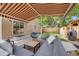 Comfortable backyard patio with gray outdoor seating, wooden table, barbecue grill, and a fenced yard for relaxation at 430 Osceola St, Denver, CO 80204