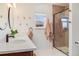 Bright bathroom features a modern vanity with dual sinks, decorative mirrors, and a glass-enclosed shower at 430 Osceola St, Denver, CO 80204