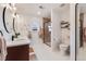 Bright bathroom boasts dual sinks, sleek fixtures, decorative mirrors, and a glass-enclosed shower at 430 Osceola St, Denver, CO 80204