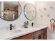 Sleek bathroom featuring double vanity with modern sinks, black fixtures, and decorative gold accents for a luxurious feel at 430 Osceola St, Denver, CO 80204