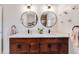 Bright bathroom with a double sink vanity, modern fixtures, and stylish mirrors at 430 Osceola St, Denver, CO 80204