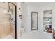 Clean bathroom with shower, toilet, sink, mirror and adjacent bedroom at 430 Osceola St, Denver, CO 80204