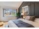 Bright bedroom with geometric accent wall, plush bedding, and a large window offering a view of the neighborhood at 430 Osceola St, Denver, CO 80204