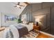 Charming bedroom with a geometric accent wall, natural light, plush bedding, and a glimpse of the outdoor view from a bright window at 430 Osceola St, Denver, CO 80204
