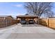 Two-car carport with a concrete floor and a wooden beam roof, enclosed by fencing at 430 Osceola St, Denver, CO 80204