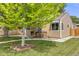 Attractive home with mature tree, landscaped yard, and cozy front porch at 430 Osceola St, Denver, CO 80204