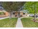Inviting home with manicured lawn, mature trees, and pleasant curb appeal at 430 Osceola St, Denver, CO 80204