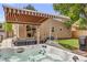 Backyard featuring a relaxing hot tub, comfortable seating, a grill, awning, and a fenced yard for outdoor enjoyment at 430 Osceola St, Denver, CO 80204
