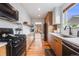 Modern kitchen with stainless steel appliances, sleek cabinets, and wood floor at 430 Osceola St, Denver, CO 80204