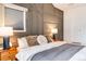 Bedroom featuring a panel wall, comfortable king bed, and hardwood floors at 430 Osceola St, Denver, CO 80204