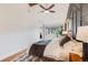 Spacious bedroom with hardwood floors, a ceiling fan, and panel wall at 430 Osceola St, Denver, CO 80204