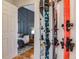 Hallway showing convenient ski storage with skis mounted on the wall, and an adjacent bedroom with a vaulted ceiling at 430 Osceola St, Denver, CO 80204