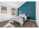 Modern bedroom with bright accent wall, sleek furnishings and bright window at 13040 W 63Rd Pl # C, Arvada, CO 80004