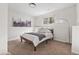A cozy bedroom features a bed, soft carpet, and natural light from the window at 13040 W 63Rd Pl # C, Arvada, CO 80004