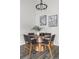 Elegant dining room featuring a round table, four chairs, and modern decor at 13040 W 63Rd Pl # C, Arvada, CO 80004