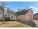 Charming house with neat front yard, attached garage, and cozy design elements under a blue sky at 13040 W 63Rd Pl # C, Arvada, CO 80004