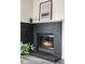 Close up of black brick fireplace with fire burning at 13040 W 63Rd Pl # C, Arvada, CO 80004