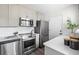 Modern kitchen with stainless steel appliances, white cabinets, and updated countertops at 13040 W 63Rd Pl # C, Arvada, CO 80004