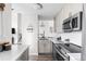 Modern kitchen with stainless steel appliances, white cabinets, and updated countertops at 13040 W 63Rd Pl # C, Arvada, CO 80004