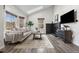 Bright living room with modern furniture, cozy fireplace, and natural light from large windows at 13040 W 63Rd Pl # C, Arvada, CO 80004