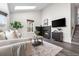 Bright living room with large windows, black brick fireplace, and comfortable furniture at 13040 W 63Rd Pl # C, Arvada, CO 80004