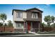 Two-story house with brown siding, red door, and stone accents at 5772 N Jebel Way, Aurora, CO 80019
