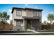 Two-story house with beige and brown siding, green door, and stone accents at 5772 N Jebel Way, Aurora, CO 80019