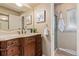Elegant bathroom featuring a carved vanity, marble countertop, and glass-enclosed shower at 7719 S Jackson Cir, Centennial, CO 80122