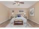 Comfortable bedroom featuring stylish decor, a ceiling fan, and beautiful hard wood floors at 7719 S Jackson Cir, Centennial, CO 80122