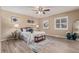 Cozy bedroom featuring stylish decor, a ceiling fan, and beautiful hard wood floors at 7719 S Jackson Cir, Centennial, CO 80122