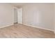 Neutral bedroom features durable plank floors, a white door, and neutral walls at 7719 S Jackson Cir, Centennial, CO 80122