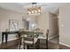 Cozy dining area featuring a modern light fixture, seating for four, and hardwood floors at 7719 S Jackson Cir, Centennial, CO 80122