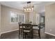 This dining room has wood floors, a window, light-colored walls and a table with four chairs at 7719 S Jackson Cir, Centennial, CO 80122