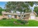 Charming single-story home with a well-manicured lawn, mature trees, and inviting curb appeal at 7719 S Jackson Cir, Centennial, CO 80122