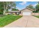 Charming home with well-manicured front yard, mature trees, and an attached two-car garage at 7719 S Jackson Cir, Centennial, CO 80122