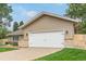 Attractive two-car garage with a white door, well-maintained lawn, and lovely exterior finish at 7719 S Jackson Cir, Centennial, CO 80122