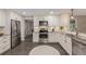 Bright kitchen featuring stainless appliances, white cabinets, and granite countertops at 7719 S Jackson Cir, Centennial, CO 80122