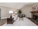 This living room has wood floors, a fireplace, a white sofa, and a high vaulted ceiling at 7719 S Jackson Cir, Centennial, CO 80122