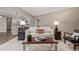 Open-concept living room with wood floors, a white sofa, and access to kitchen at 7719 S Jackson Cir, Centennial, CO 80122