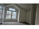 Empty room features plush carpet and a large bright window at 18531 E Tanforan Pl, Aurora, CO 80015