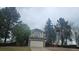 Charming two-story home with stone accents, lush trees, and an attached two-car garage at 18531 E Tanforan Pl, Aurora, CO 80015