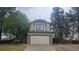 Charming two-story home with stone accents, lush trees, and an attached two-car garage at 18531 E Tanforan Pl, Aurora, CO 80015