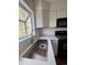 Bright kitchen featuring a stainless steel sink, white cabinets, and black appliances at 18531 E Tanforan Pl, Aurora, CO 80015