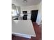 Bright kitchen with stainless steel appliances, white cabinets, and a breakfast bar at 18531 E Tanforan Pl, Aurora, CO 80015