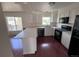 Bright kitchen with stainless steel appliances, white cabinets, and a breakfast bar at 18531 E Tanforan Pl, Aurora, CO 80015