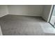 Bright living room with plush carpeting and sliding glass doors to a patio at 18531 E Tanforan Pl, Aurora, CO 80015