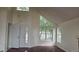 Bright living room with tall ceilings, hardwood floors, and large windows allowing for natural light at 18531 E Tanforan Pl, Aurora, CO 80015